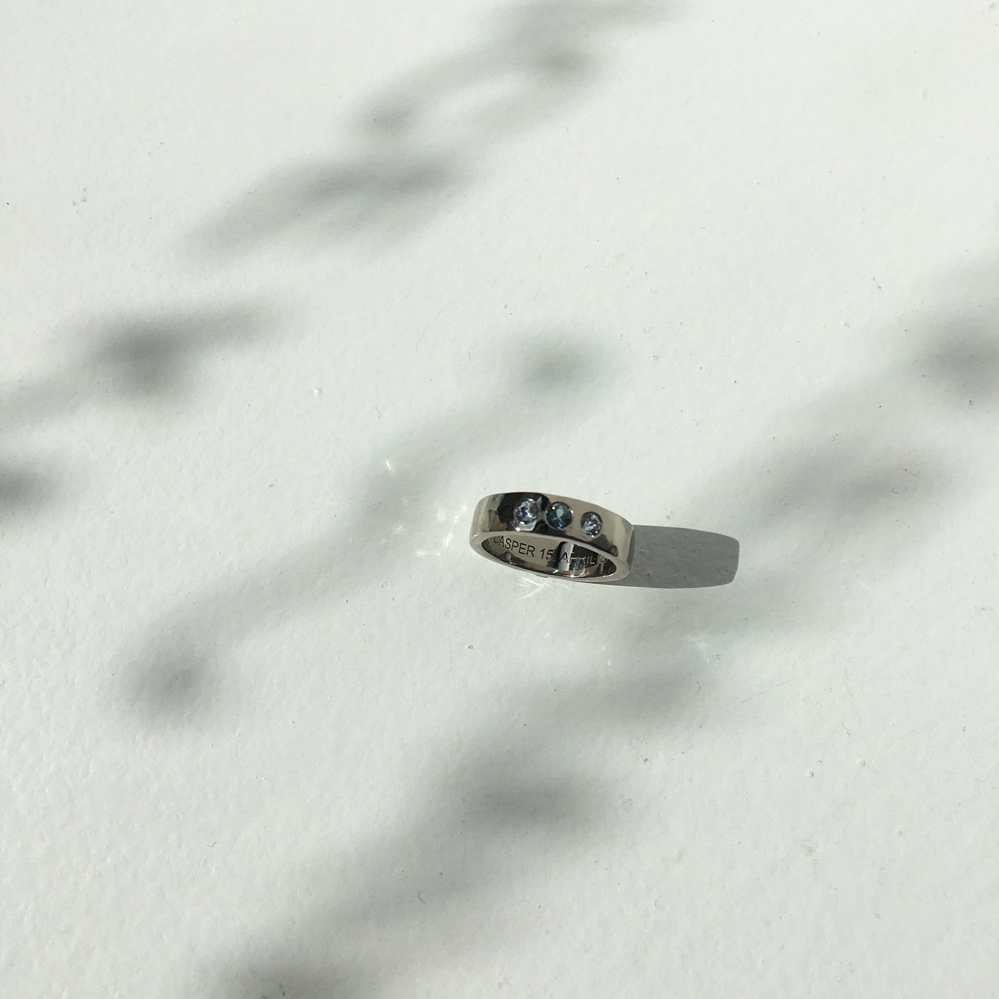 14k white gold hammered ring with three sapphires
