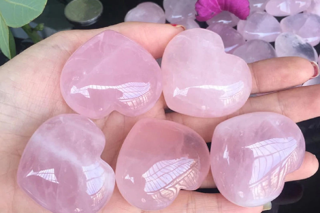 Five heart shaped pink quartz crystals