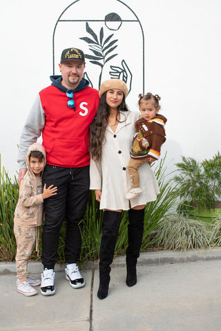 Photo of Natalie and family: her son Diego (far left), her husband Vlad (second from left), Natalie (center), Rio (right)