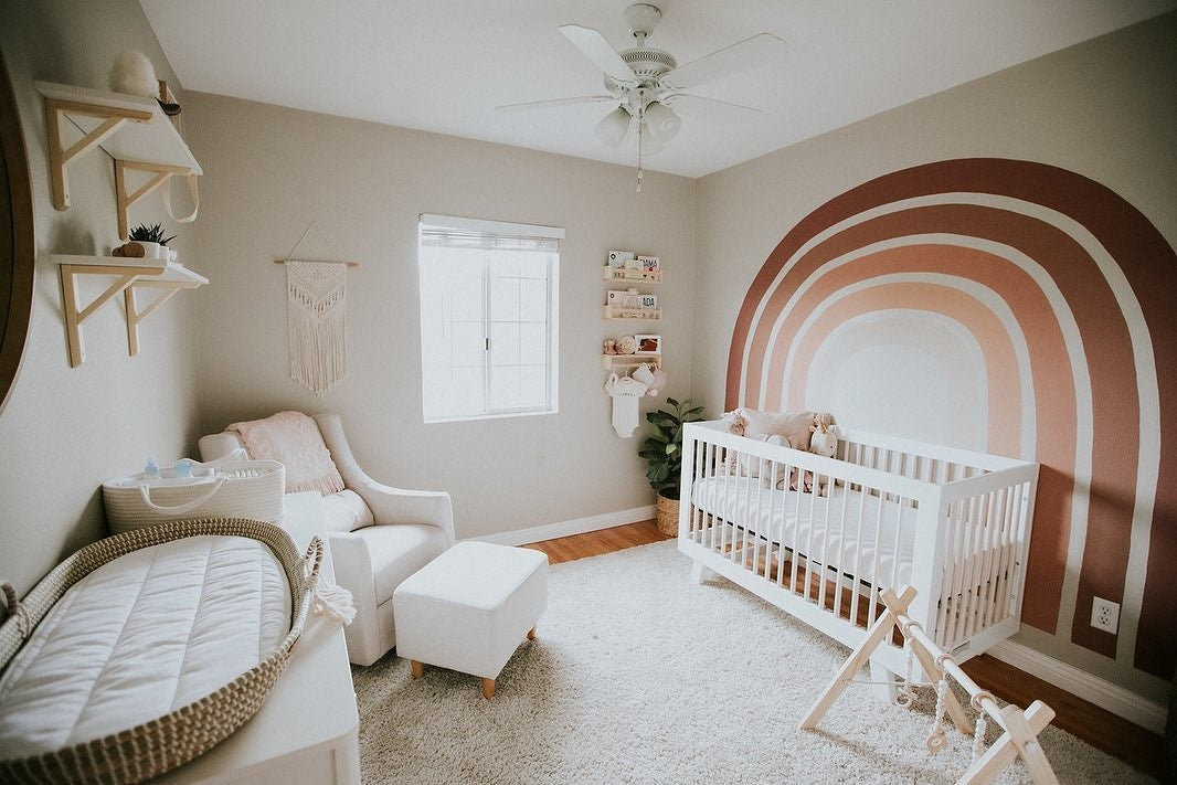 Boho red-toned rainbow nursery featuring babyletto's Hudson Crib, Lolly Dresser, and Toco Glider and Ottoman