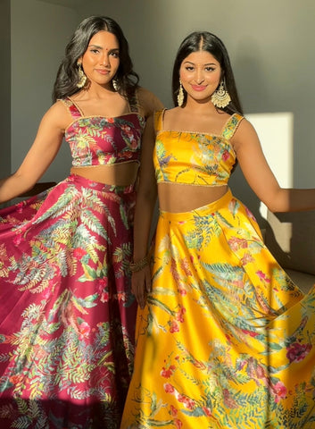 Vishakha and Drisya in Harleen Kaur Caribbean Floral Print Lehengas in Wine Red and Sunflower Yellow