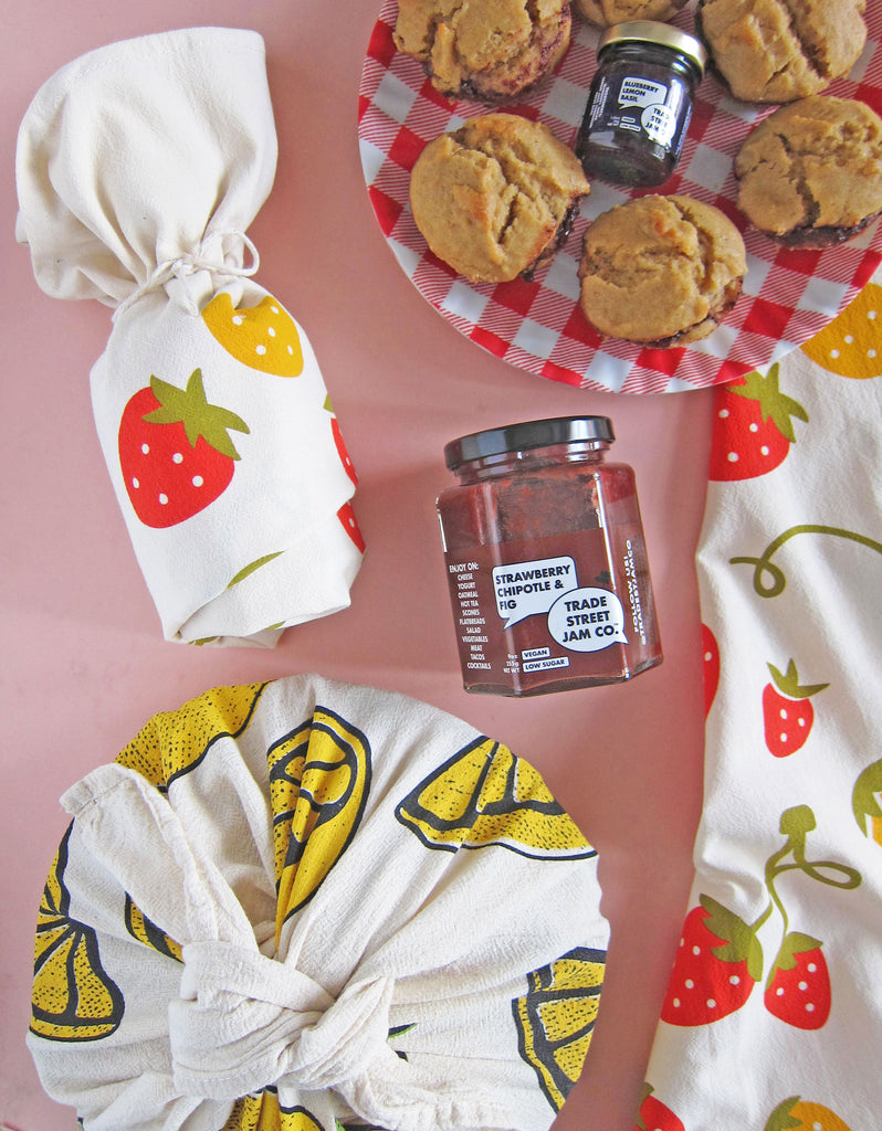 jam and muffins wrapped in dish towels