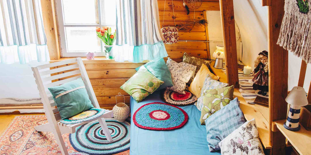 Image depicting a cosy day bed with maximalist inspiration, which includes a riot of colors, patterns, and accessories, accompanied by the title 'Crafting a Maximalist Plan: First Steps to Home Renovation.' This visual sets the stage for a maximalist home renovation, showcasing the limitless possibilities for personal expression