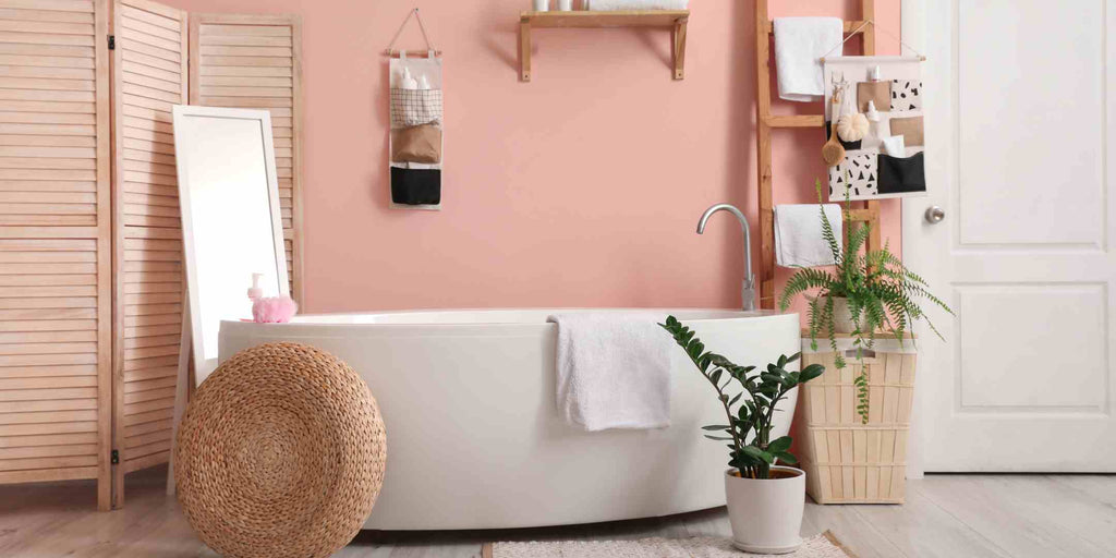 Image representing a space optimisation technique for HDB Executive Maisonette renovations, highlighting the strategic use of light color palettes and lighting. The picture shows a bathroom interior with light pink hues, making the space look larger and brighter.