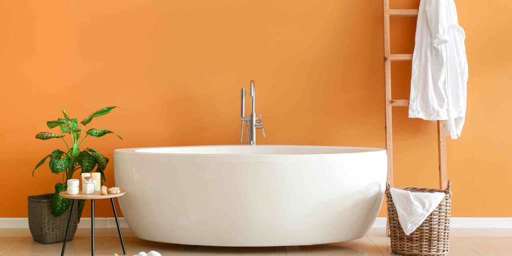Image demonstrating home renovation concepts for creating ideal low-light interiors, emphasizing the best paint colors for low-light HDB interiors. Features a warm-toned bathroom with a sunrise orange wall, adding vibrancy and a welcoming ambiance to the space, effectively brightening up the low-light environment.