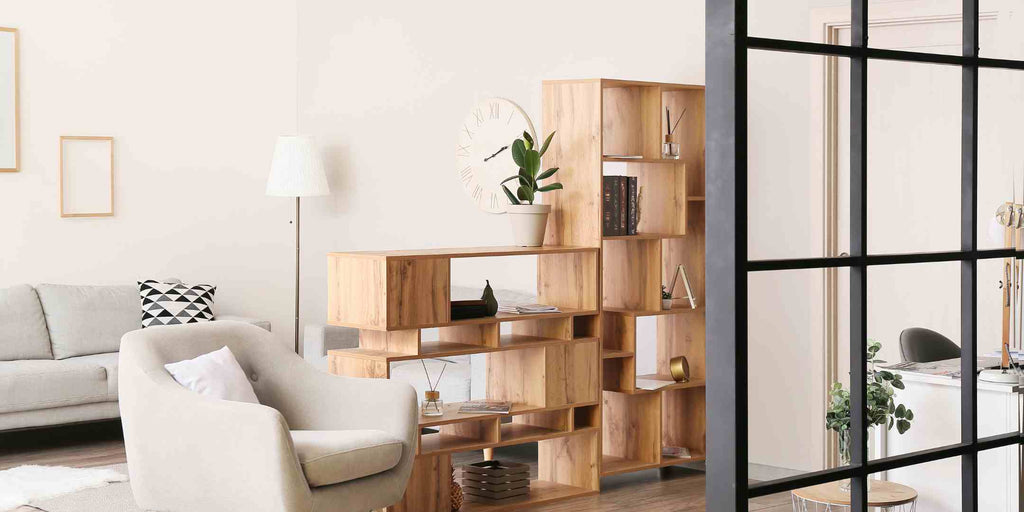 A tastefully decorated small condo featuring a bookcase room divider.his transformative furniture solution serves as a savvy, budget-conscious renovation idea for small condo spaces