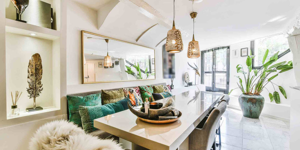 An elegantly renovated small condo dining area, leveraging mirrors and lighting to create the illusion of space.