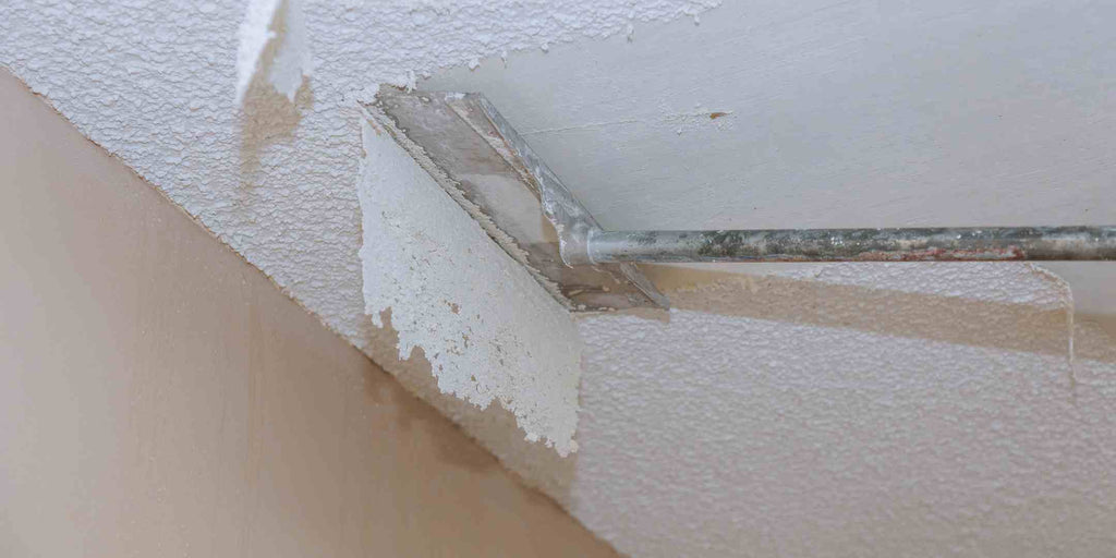 The image of scraping off paint from a ceiling, illustrating the metaphor of uncovering hidden issues or costs that can come with unusually low quotes in the renovation industry, emphasizing the message that cheaper isn't always better