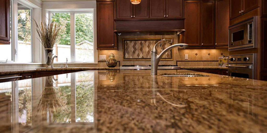 Image of a modern condo kitchen showcasing a brown marbled backsplash counter with a reflective surface. The backsplash not only adds an element of luxury but also amplifies light and gives the illusion of a more expansive space. This photo illustrates an effective strategy in optimizing a condo's floor plan, using reflective surfaces to enhance both the aesthetic and spatial perception of a room.