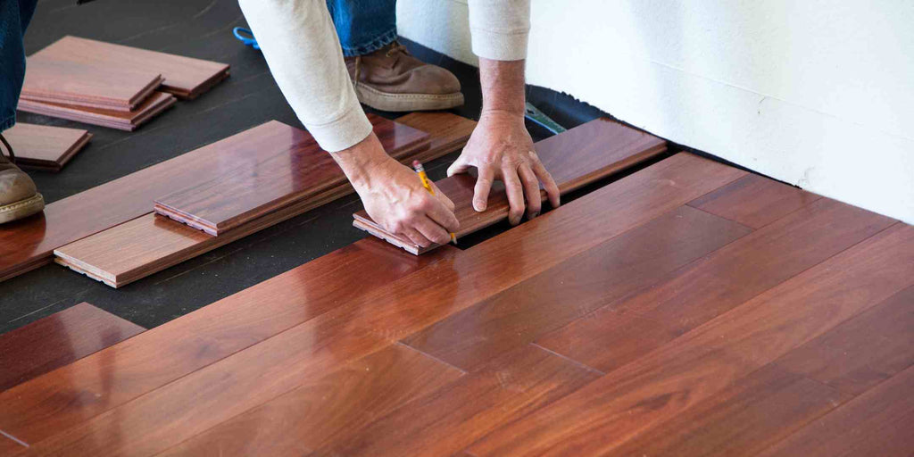 Image depicting the installation of a wooden floor in a Singaporean condo, potentially symbolizing a violation of condo renovation rules if not done in accordance with the guidelines. The picture serves as a cautionary representation of renovations that might conflict with building rules, highlighting the need for careful consideration and approval before altering fundamental aspects like flooring in a condo.