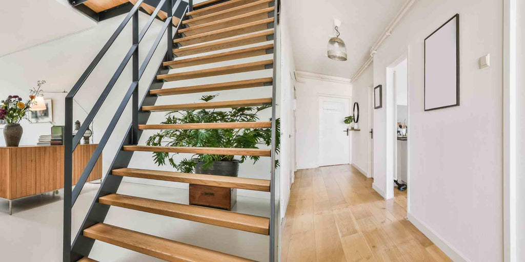 Split image showcasing creative ideas for underutilised areas in a maisonette. The left side features an underutilised space beneath the staircase, while the right side presents a narrow corridor