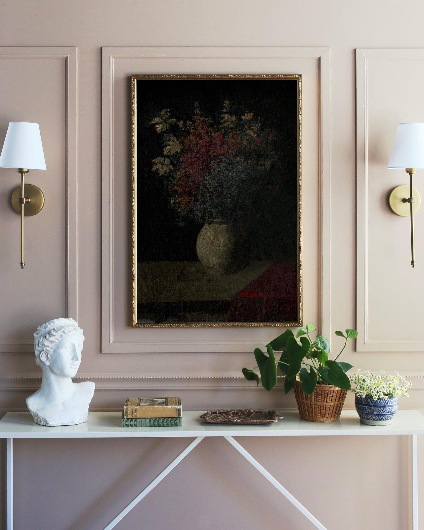 We love the look of sconces tucked inside wainscoting in a dining room to accent your artwork! www.juniperprintshop.com