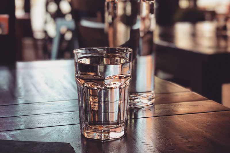 glass cup filled with water with blur indoor background