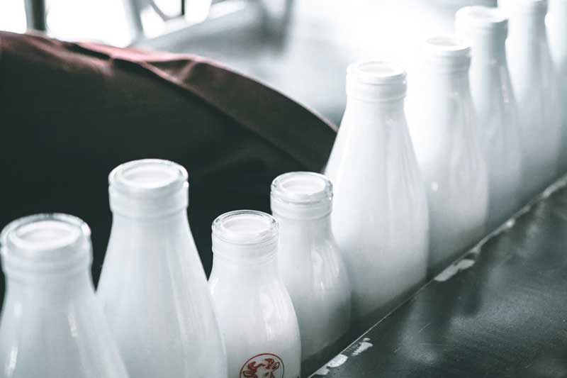 close-up shoot of glass bottled dairy products with blur background