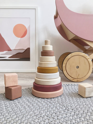 Wooden toy - Sabo Stacking Pyramid in Pink A classic conical stacking tower in a beautiful terracotta and spruce palette. The graduated stacking rings create a simple first “puzzle” for toddlers and preschoolers