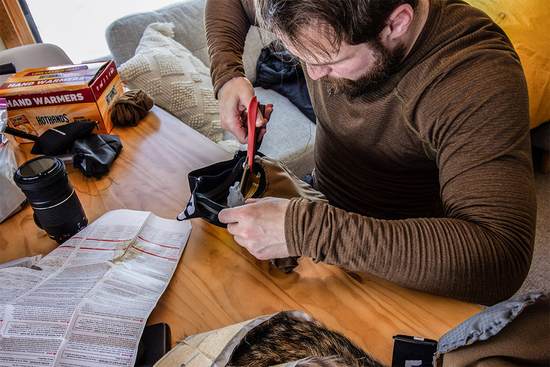 Product tester cutting fabric indoors to make custom Bird Beak for an arctic simulation.