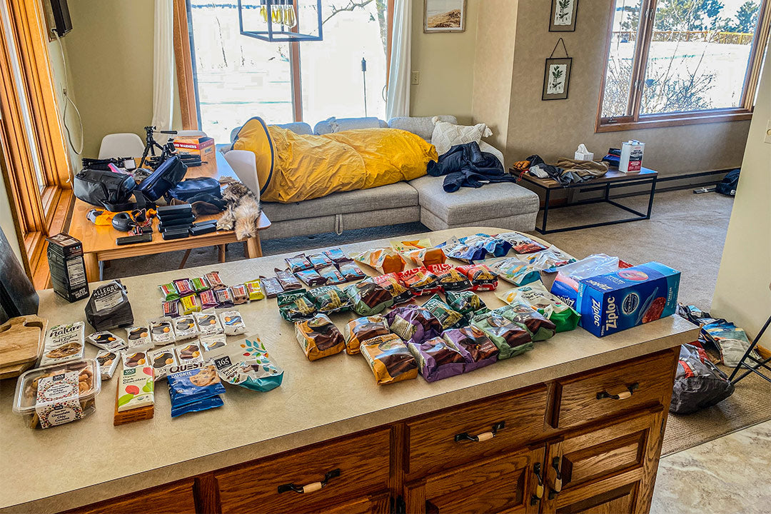 Food items for arctic simulation trip laid out on a kitchen counter.