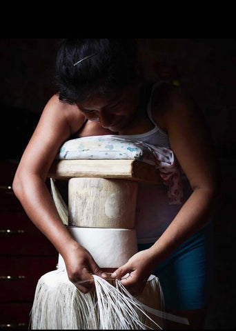 woman making a panama hat