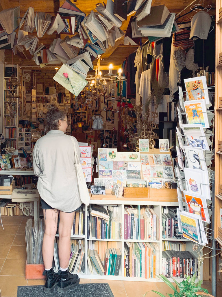 Girl shopping cards in a book shop