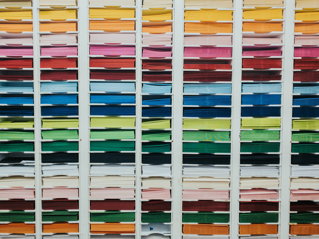 Wall of coloured enveloppes in a store