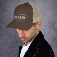 Thumbnail for man wearing a 3/4 view of a square body suburban trucker hat from aggressive thread in brown