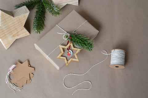 gift wrapped in brown paper with leaf sprig