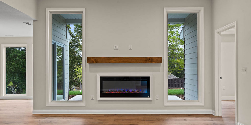 Touchstone Sideline Smart Electric Fireplace installed in light gray accent wall with wood mantel by home builder Hemme Construction