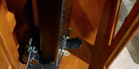 The Touchstone Whisper Lift II TV Lift mechanism mounted to the the base of the cabinet. 