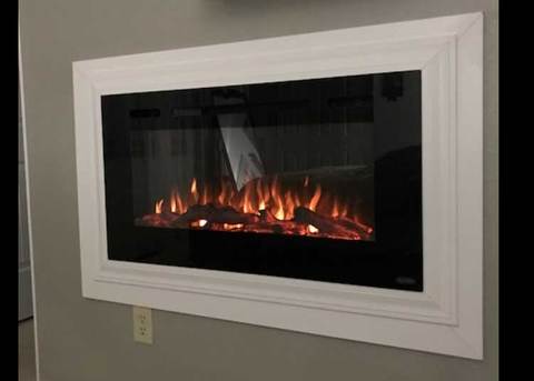 Sideline 40 Electric Fireplace recessed and framed with white trim