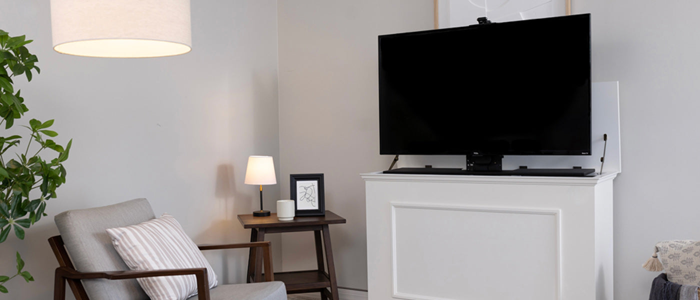 Touchstone Elevate TV Lift Cabinet in white with TV attached to TV mount