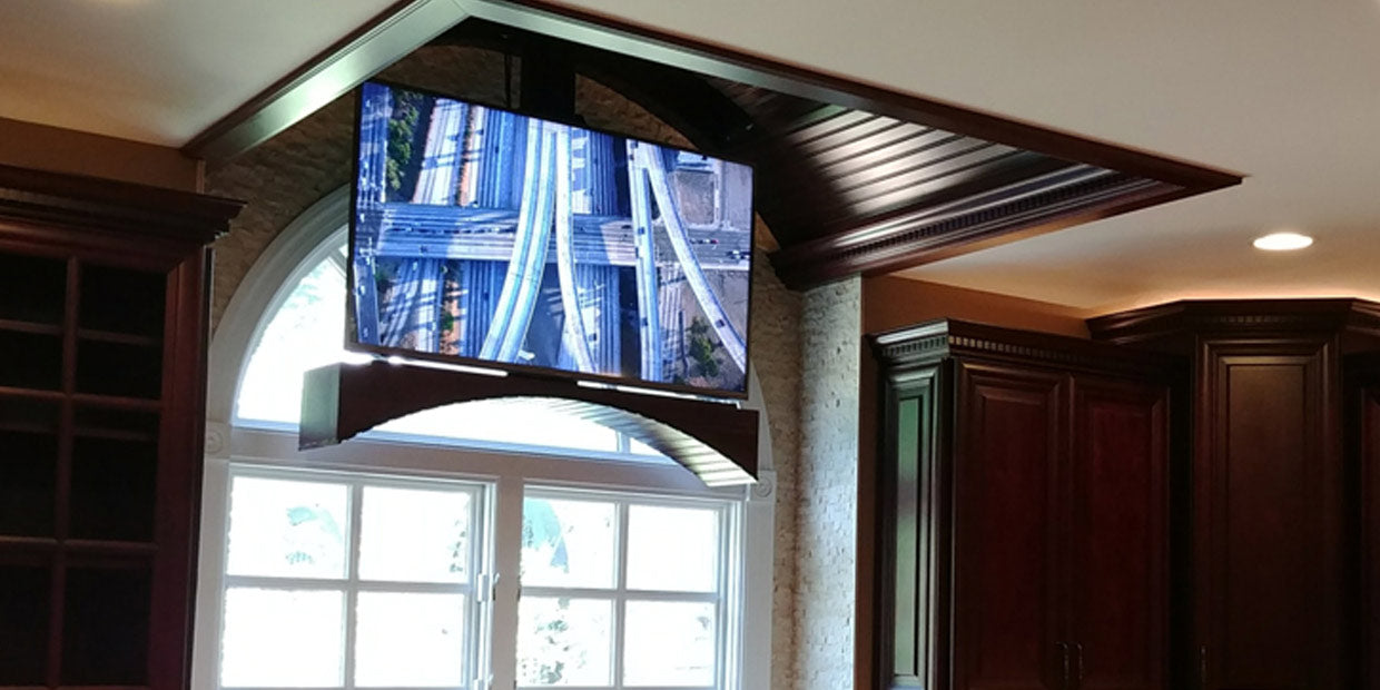 Touchstone Whisper Lift II TV lift installed in the kitchen ceiling for a dramatic dropdown TV viewing effect
