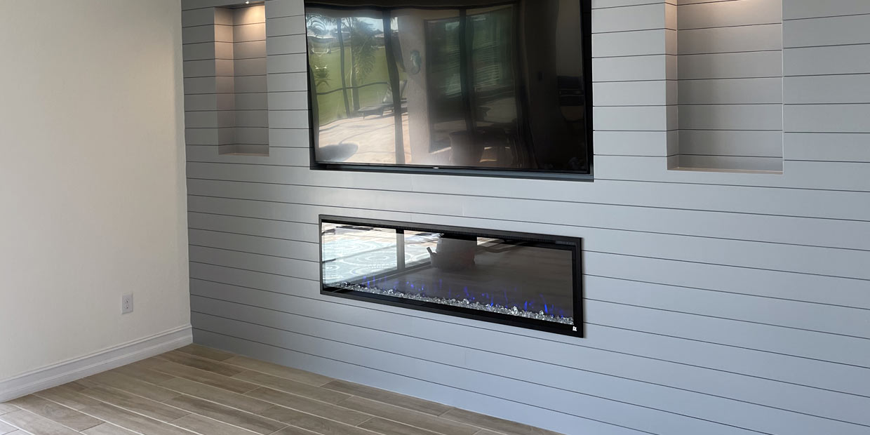 Touchstone Sideline Elite Electric Fireplace in a gray shiplap accent wall by Umbare Home Remodel Online