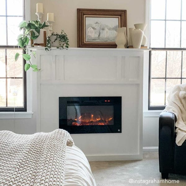 Touchstone Sideline 28 Electric Fireplace in bedroom in custom built white mantel