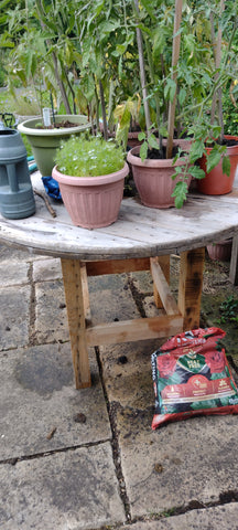 Table made from reclaimed wood pallets with a top crafted from cable spool wood. Rustic charm and recycling uniqueness give this table a distinctive character.