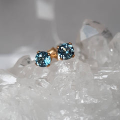 Marie Nicole Bijoux - London Blue Topaz stud earrings on a crystal