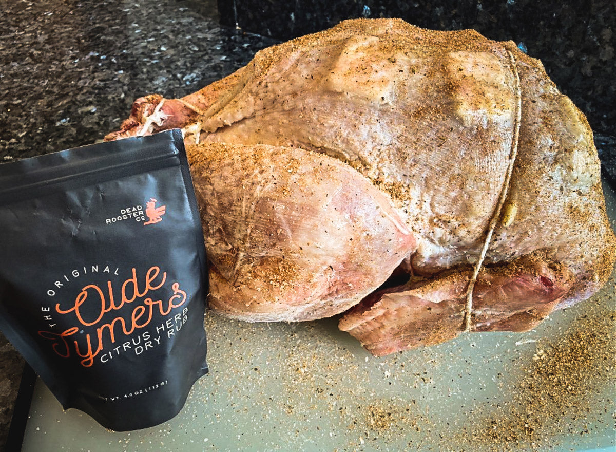 Photo of raw turkey covered in herb dry rub seasoning