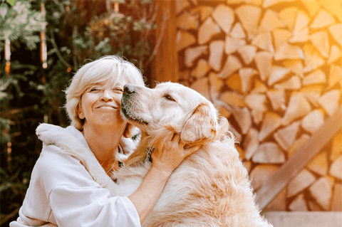 Blond woman hugging his dog