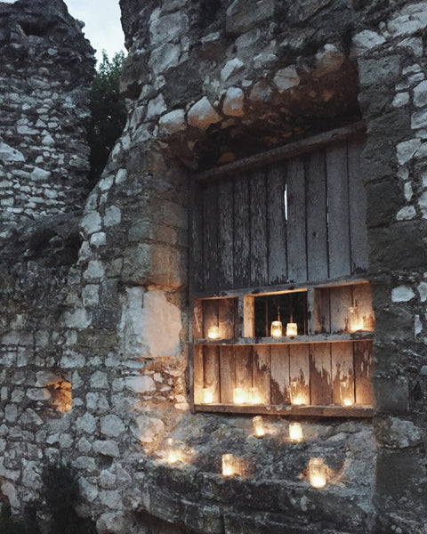 Magical evening with Lewes Priory lit up by candles.