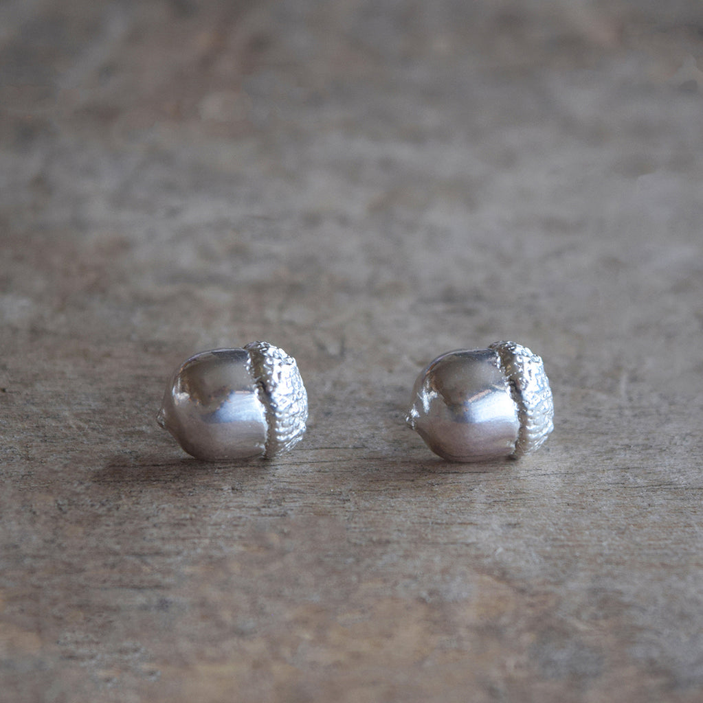 Little Acorns Mighty Oaks Grow earrings by Alice Stewart Jewellery. Handcrafted in solid sterling silver, these delicate silver acorn earrings measure 10mm by 10mm and have butterfly backs. Free gift wrapping and shipped using eco-friendly packaging.
