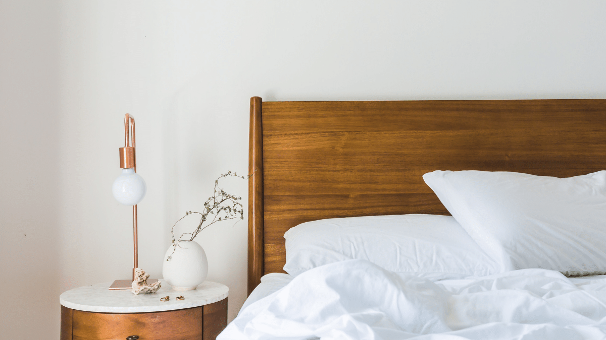 wooden bed with white linen