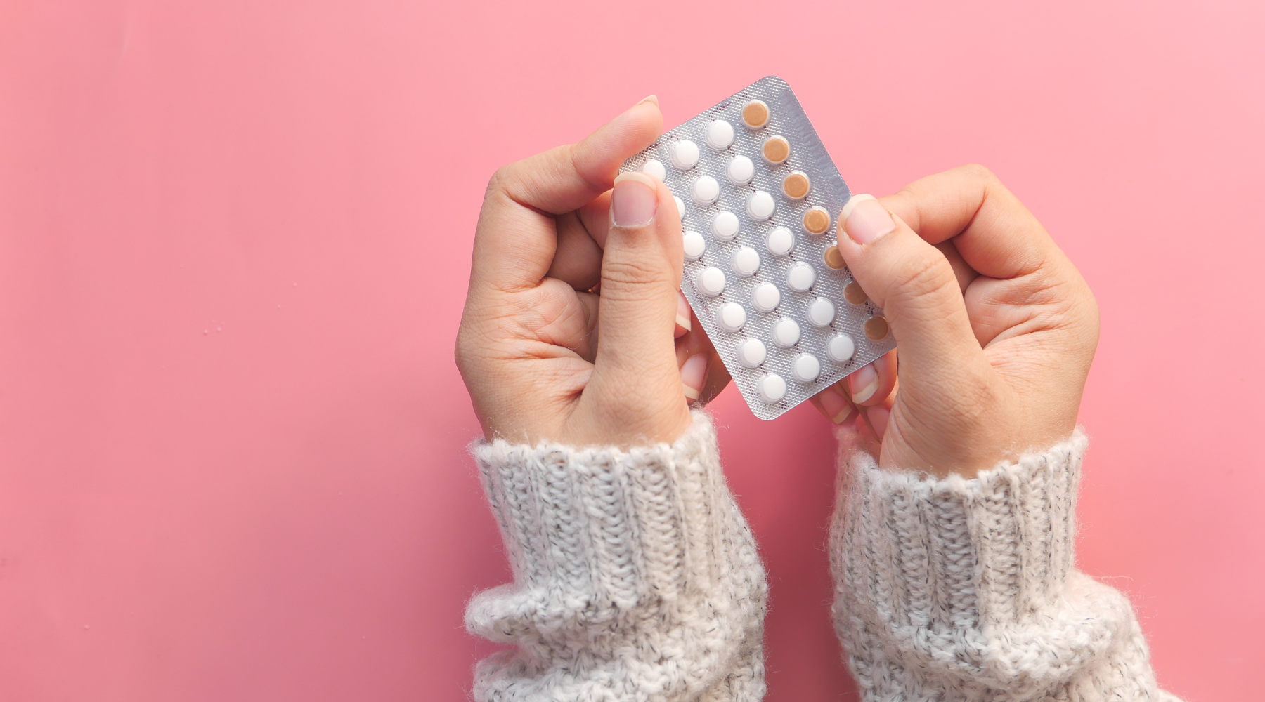 hands holding birth control pill