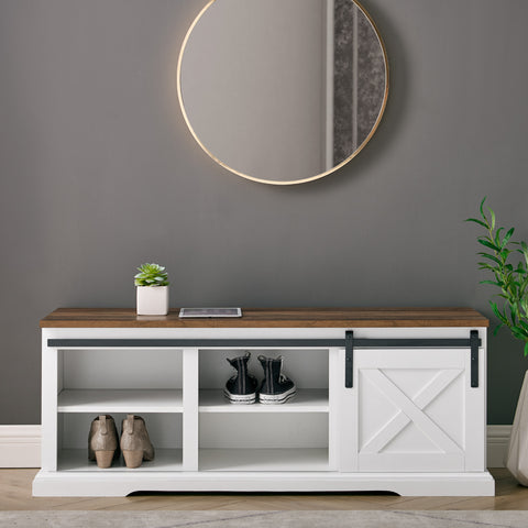 Rustic farm door entry bench with lots of storage in a grey entryway with a large round mirror above it.