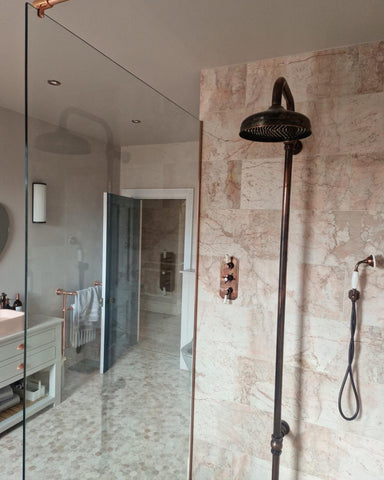 Polished copper U Channel was used to secure this glass shower screen