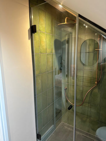 Shower glass door with matte black hinges and door knob