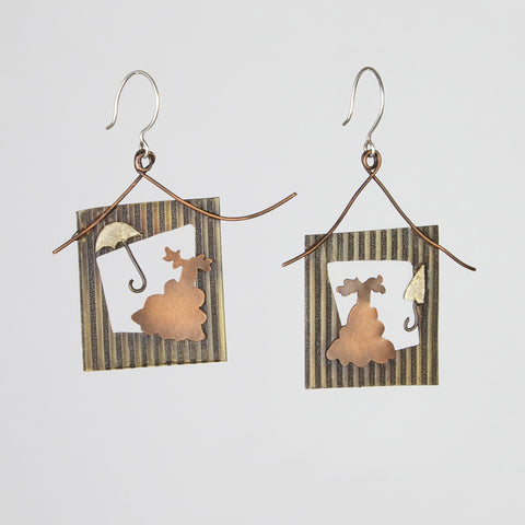 Earrings inspired by the words southern and portrait depict picture frames with ball gowns and parasols.