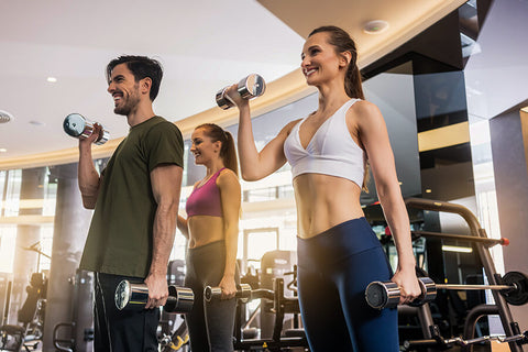 A group of fitness enthusiasts lifts weights