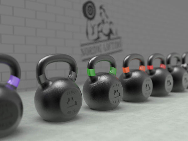 A pile of Nordic Lifting Kettlebells in various weights.