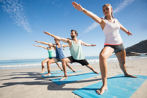 A group of people working out on the beach front