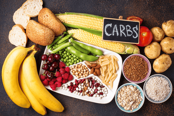 A Visual Representation Of Carbohydrate Foods Laid Out In The Table With Fruits, Vegetable, Nuts, Berries, And Pasta