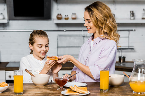 A mother makes her daughter delicious and sweet french toast